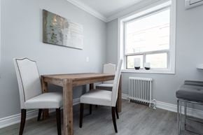 Hamilton apartment for rent - A dining room with a wooden table and chairs.
