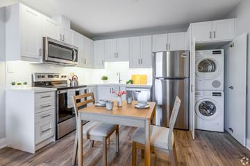 Stoney Creek apartment for rent - A modern kitchen with a dining table and chairs.