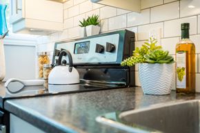 Hamilton apartment for rent - A modern kitchen with a stove top and a microwave.
