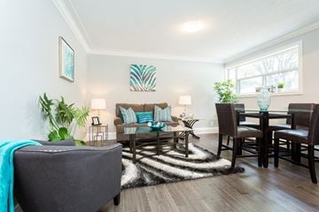 Hamilton apartment for rent - A living room with a grey couch and a wooden table.