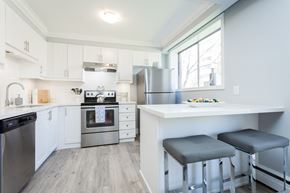 Hamilton apartment for rent - A kitchen with white cabinets and a stainless steel oven.