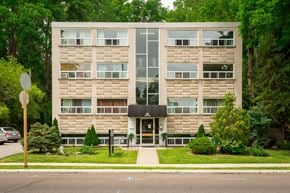 Hamilton apartment for rent - A modern building with a black awning at the entrance.