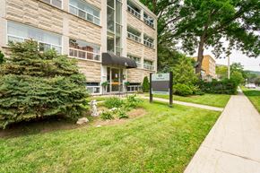 Hamilton apartment for rent - A building with a brown and beige exterior with a black awning and a sign that says 90.