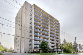 Toronto apartment for rent - A tall residential building with balconies on the upper floors.