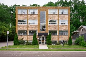 Hamilton apartment for rent - A building with a brown brick facade and a black awning.