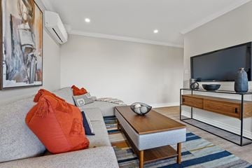 North York apartment for rent - A living room with a grey couch, a coffee table, and a painting on the wall.