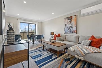 Stoney Creek apartment for rent - A living room with a grey couch, a coffee table, and a painting on the wall.