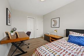 Stoney Creek apartment for rent - A bedroom with a bed, desk, and chair.