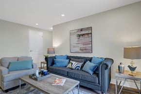 Hamilton apartment for rent - A living room with a grey couch and a coffee table.