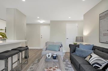 Hamilton apartment for rent - A modern living room with a grey couch and a coffee table.