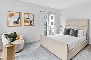 Scituate apartment for rent - a bedroom with a bed and a chair and a door to a balcony
