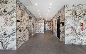 Los Angeles apartment for rent - a view of the elevators in the lobby of a building with marble walls and floors