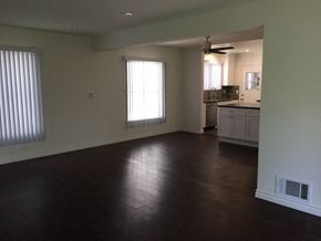 West Hollywood apartment for rent - an empty living room with a kitchen in the background