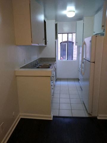 Los Angeles apartment for rent - an empty kitchen with a sink and a refrigerator