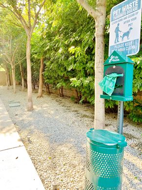 Los Angeles apartment for rent - a green trash can sitting next to a tree