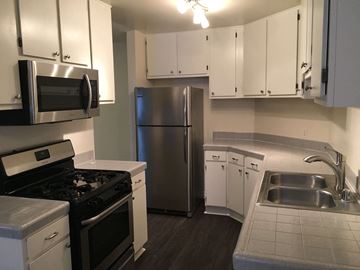 Los Angeles apartment for rent - a kitchen with stainless steel appliances and white cabinets