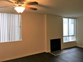 Los Angeles apartment for rent - a living room with two windows and a ceiling fan