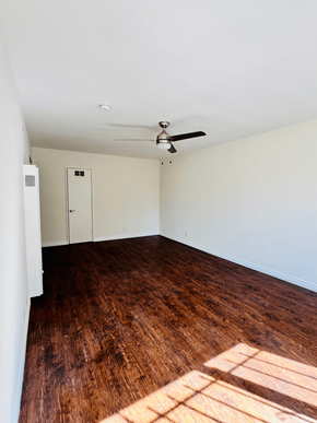 West Hollywood apartment for rent - an empty living room with wood floors and a ceiling fan