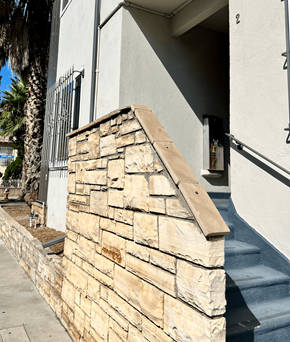 West Hollywood apartment for rent - a small stone wall in front of a house