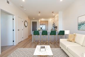 Bozeman apartment for rent - a living room with a couch and a bar with four stools