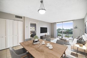 Lauderhill apartment for rent - A modern dining room with a wooden table set for two.