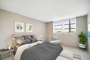Lauderhill apartment for rent - A bedroom with a large bed and a window with blinds.