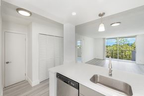 Lauderhill apartment for rent - A modern kitchen with a stainless steel sink and white countertops.