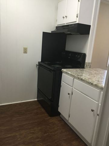 Fayetteville apartment for rent - A black oven and stove top are on a kitchen island.