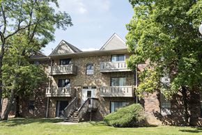 Louisville apartment for rent - A large house with a balcony and a staircase leading to the entrance.