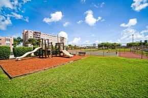 North Miami apartment for rent - A playground with a slide and a basketball court.