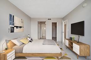 North Miami apartment for rent - A bedroom with a bed, nightstand, and a television.