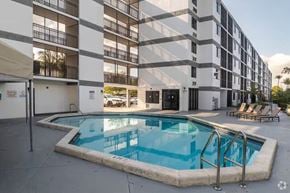 Miami apartment for rent - A small pool in front of a building.