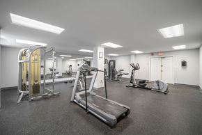Miami apartment for rent - A gym with a treadmill, weights, and exercise equipment.