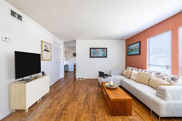 Tampa apartment for rent - A living room with a white couch and a wooden coffee table.