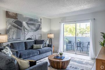Miami apartment for rent - A living room with a grey couch and a wooden coffee table.