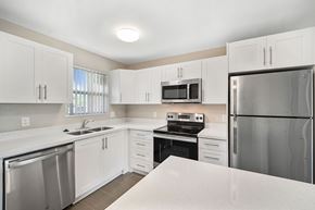 West Palm Beach apartment for rent - A kitchen with white cabinets and stainless steel appliances.