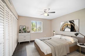 West Palm Beach apartment for rent - A bedroom with a bed, nightstand, and a painting on the wall.