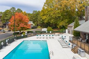 Raleigh apartment for rent - a swimming pool with lounge chairs next to a house