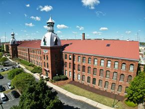 Augusta apartment for rent - A large red brick building with a tower and a clock on the front.