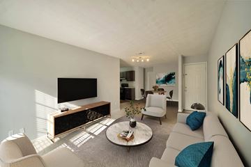 Decatur apartment for rent - A living room with a grey couch and a coffee table.
