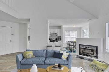 Raleigh apartment for rent - A living room with a grey couch and a fireplace.