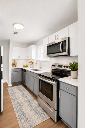 Raleigh apartment for rent - A kitchen with a stove top oven and a microwave above it.