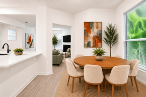Raleigh apartment for rent - A dining room with a round wooden table surrounded by chairs.