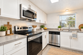 Largo apartment for rent - A modern kitchen with white cabinets and stainless steel appliances.
