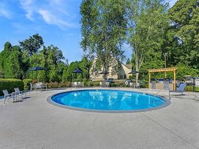 Decatur apartment for rent - a blue swimming pool with chairs and umbrellas around it