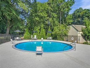 Decatur apartment for rent - a blue swimming pool with chairs around it