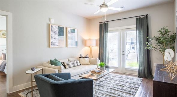 Oakwood apartment for rent - a living room with a couch and a chair and sliding glass doors