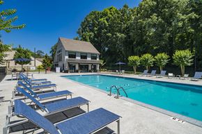 Decatur apartment for rent - A pool with sun loungers and a building in the background.