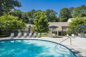 Decatur apartment for rent - A swimming pool surrounded by trees and chairs.