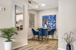 Cary apartment for rent - a dining room with a table and chairs and a painting on the wall